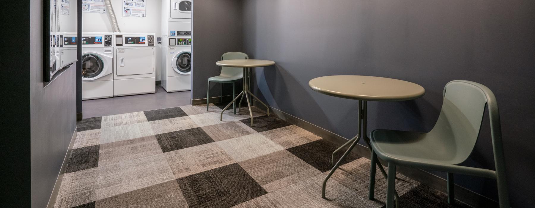 waiting room for laundry with tables and chairs